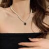 Elegant Pearl Necklace with Black Heart Pendant